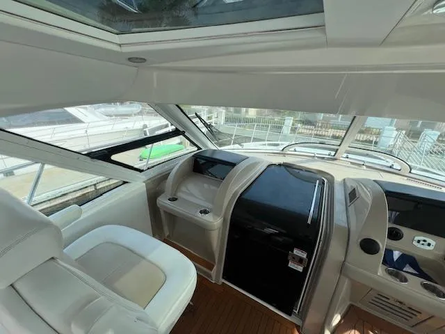 Slide: The Image of Interior view of 2008 Sea Ray 55 Sundancer yacht cockpit with modern controls and seating. - 19