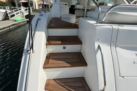 Slide: The Image of Staircase on 2008 Sea Ray 55 Sundancer yacht, featuring wooden steps and white railing. - 23