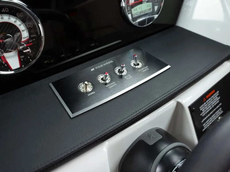 Slide: The Image of 2025 Four Winns H1 dashboard with control switches and speedometer. - 16