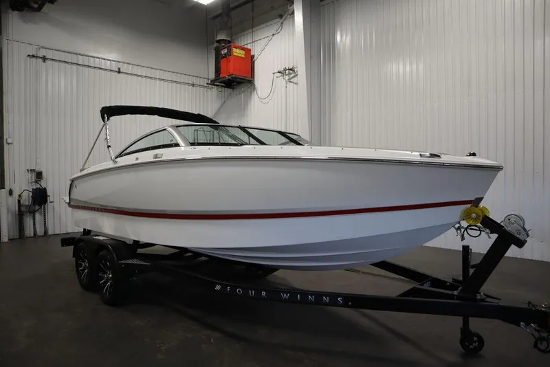 Slide: The Image of 2025 Four Winns H1 boat on trailer in indoor storage facility. - 21