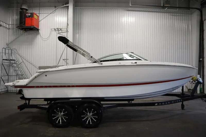 Slide: The Image of 2025 Four Winns H1 boat on trailer in indoor storage facility. - 23