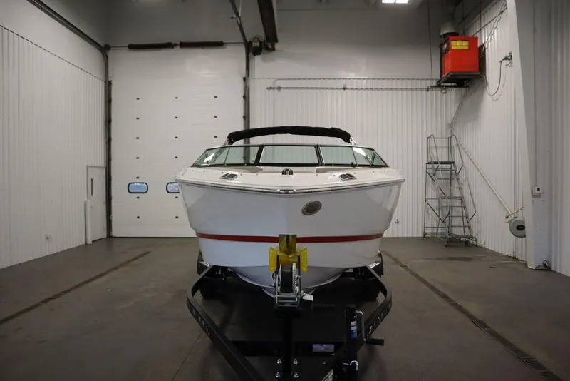 Slide: The Image of 2025 Four Winns H1 boat in a spacious indoor storage facility. - 25