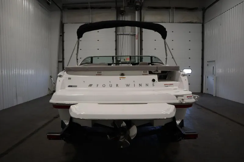 Slide: The Image of 2025 Four Winns H1 boat in a garage, rear view. - 26