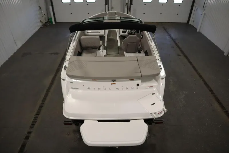 Slide: The Image of 2025 Four Winns H1 boat interior, rear view in a garage setting. - 3