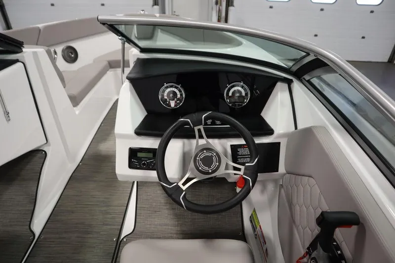 Slide: The Image of 2025 Four Winns H1 boat cockpit with modern steering wheel and dashboard controls. - 31