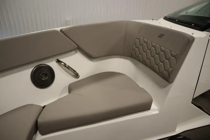 Slide: The Image of 2025 Four Winns H1 boat interior with beige seating and hexagonal pattern design. - 34