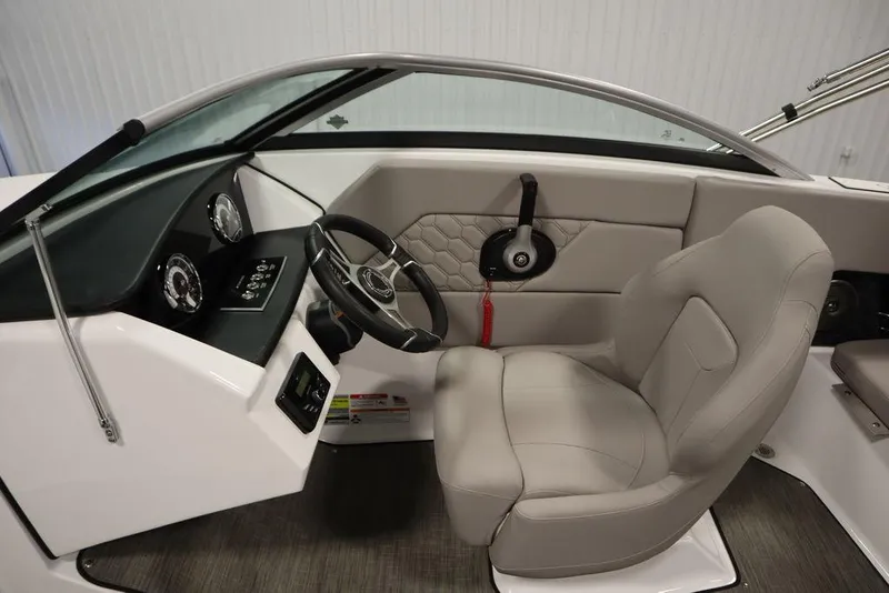 Slide: The Image of 2025 Four Winns H1 boat interior with steering wheel and dashboard controls. - 35