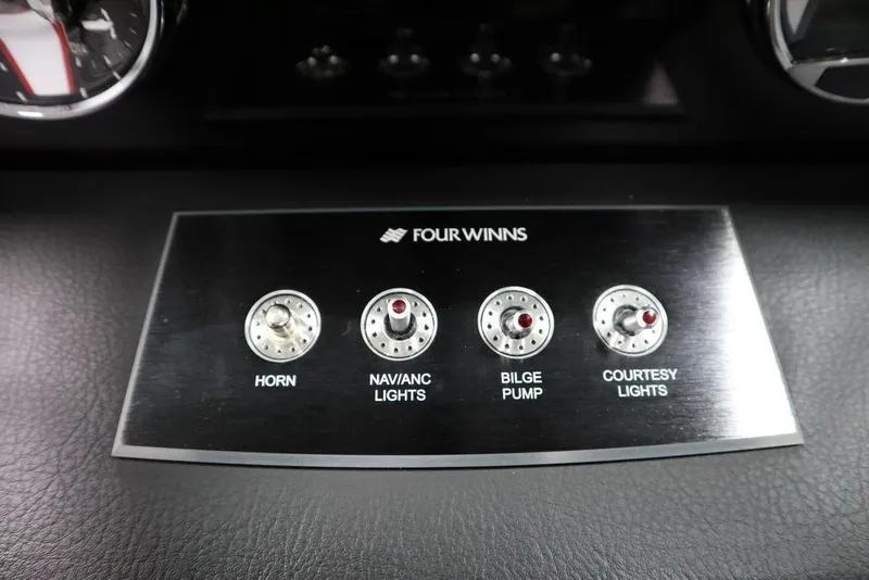 Slide: The Image of Control panel of 2025 Four Winns H1 boat with switches for horn, lights, and bilge pump. - 39