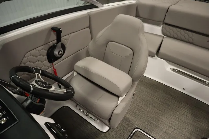 Slide: The Image of 2025 Four Winns H1 boat interior with gray seating and steering wheel. - 46