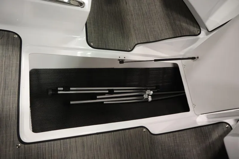 Slide: The Image of 2025 Four Winns H1 boat storage compartment with metal poles inside. - 48