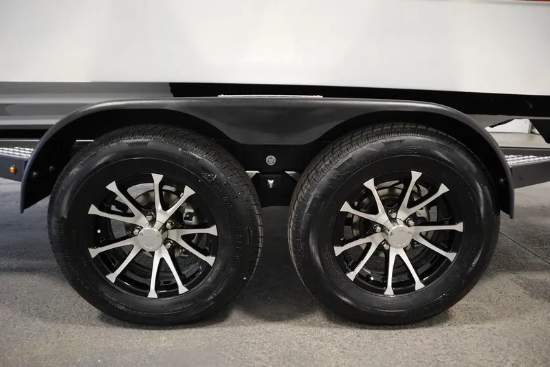 Slide: The Image of 2025 Four Winns H1 trailer wheels with sleek black and silver rims. - 9