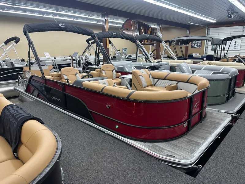 The Image of 2025 Crest Classic 220 pontoon boat with tan seating in showroom. - 0
