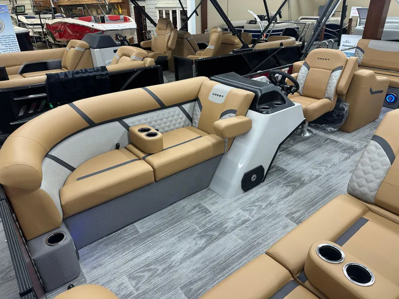 Slide: The Image of 2025 Crest Classic 220 pontoon boat interior with tan seating and modern design. - 3