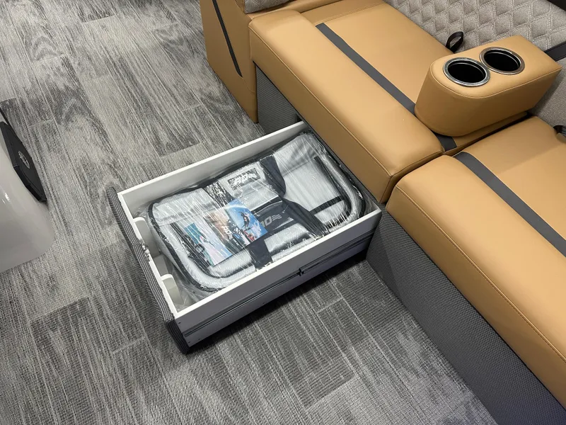 Slide: The Image of 2025 Crest Classic 220 interior with storage drawer and tan seating. - 4