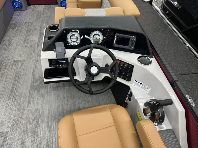 Slide: The Image of 2025 Crest Classic 220 boat dashboard with steering wheel and modern controls. - 9