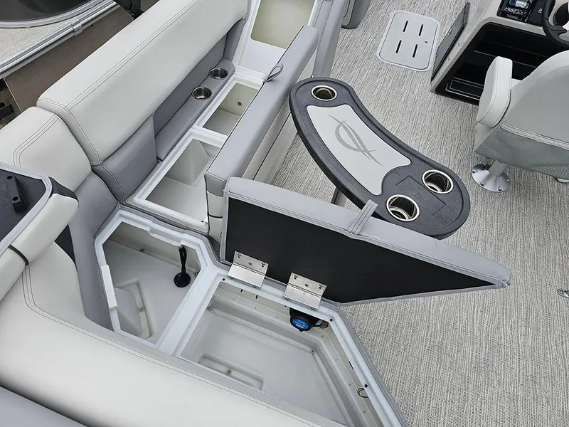 Slide: The Image of 2025 SunCatcher Select 322C boat interior with storage compartments and cup holders. - 12