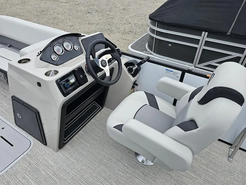 Slide: The Image of 2025 SunCatcher Select 322C boat interior with steering console and captain's chair. - 13