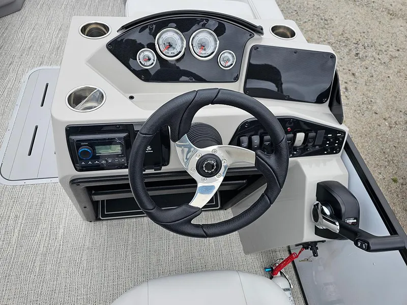 Slide: The Image of 2025 SunCatcher Select 322C boat dashboard with steering wheel and control panel. - 14