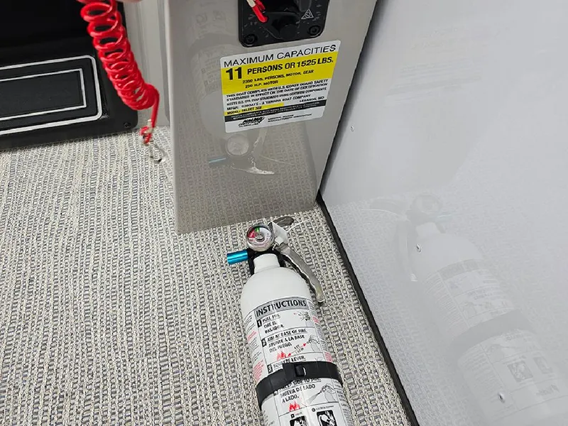 Slide: The Image of Fire extinguisher on SunCatcher Select 322C boat, 2025 model, near capacity label. - 16