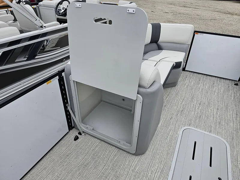 Slide: The Image of 2025 SunCatcher Select 322C boat interior with open storage compartment and seating. - 19