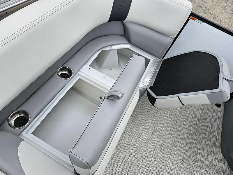 Slide: The Image of 2025 SunCatcher Select 322C boat seat storage with cup holders and open compartment. - 20
