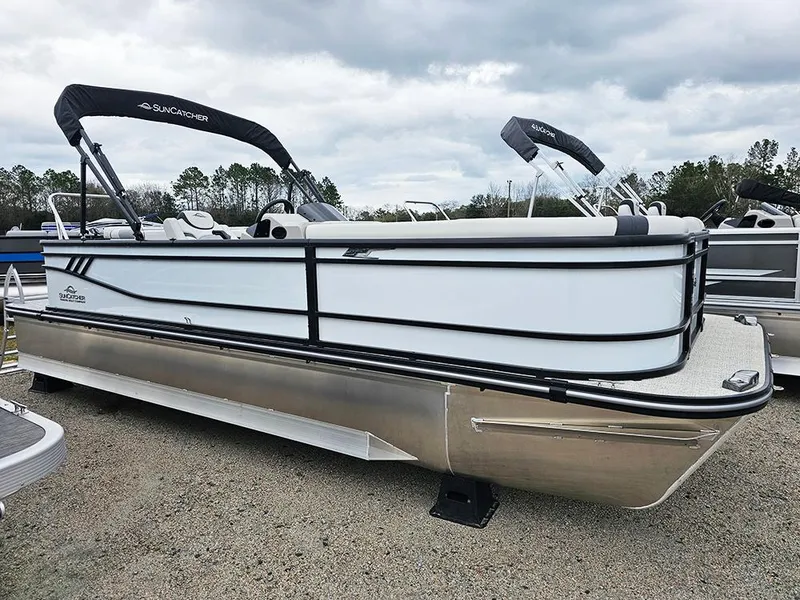 Slide: The Image of 2025 SunCatcher Select 322C pontoon boat, white exterior, parked outdoors. - 5
