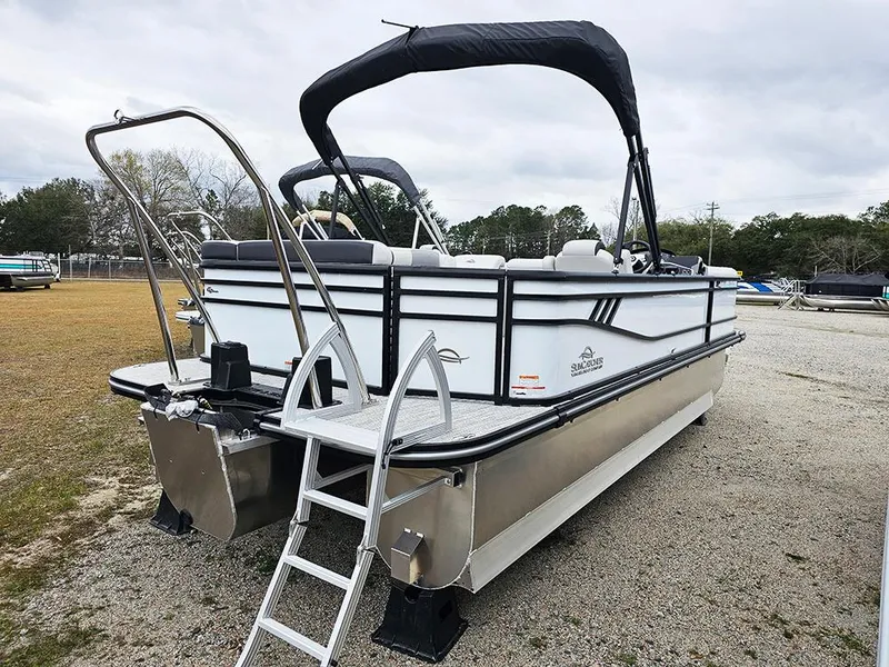 Slide: The Image of 2025 SunCatcher Select 322C pontoon boat with ladder and canopy, parked on gravel. - 6