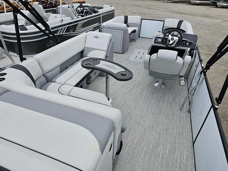 Slide: The Image of 2025 SunCatcher Select 322C pontoon boat interior with plush seating and modern helm. - 7