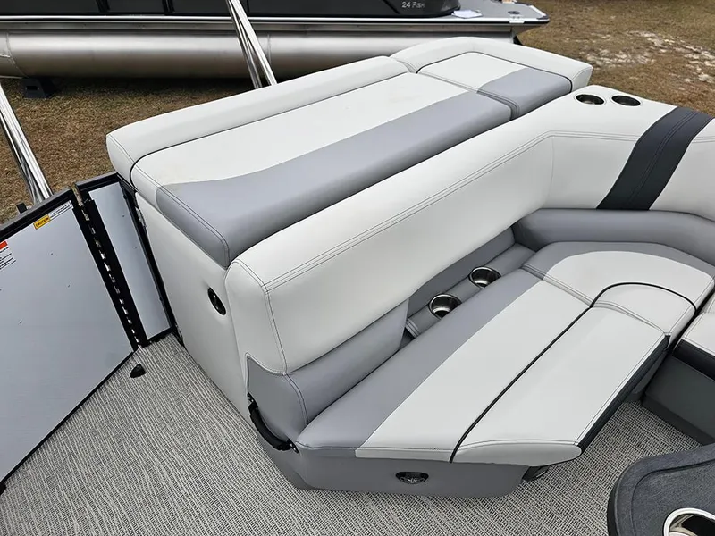 Slide: The Image of 2025 SunCatcher Select 322C boat interior with gray and white seating and cup holders. - 9