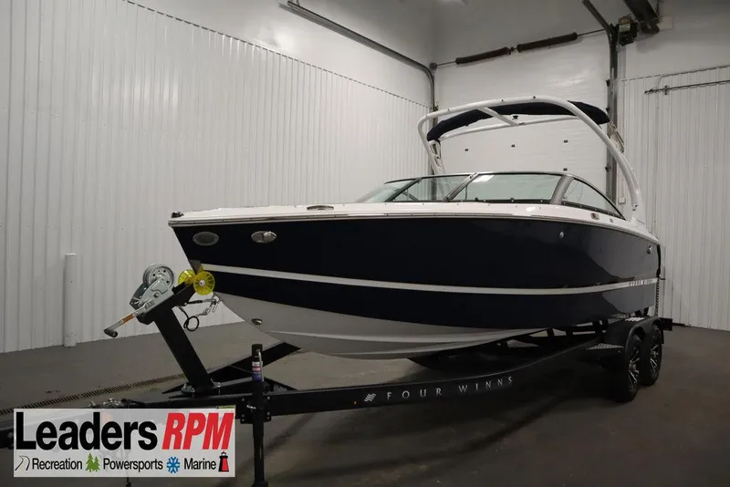 The Image of 2025 Four Winns H2 boat on trailer in indoor showroom. - 1