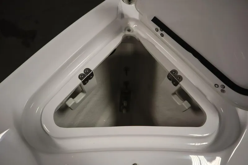 Slide: The Image of Open storage compartment in 2025 Four Winns H2 boat, showcasing interior design and hinges. - 11