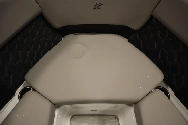 Slide: The Image of 2025 Four Winns H2 boat interior seating with sleek, modern design and hexagonal pattern. - 14