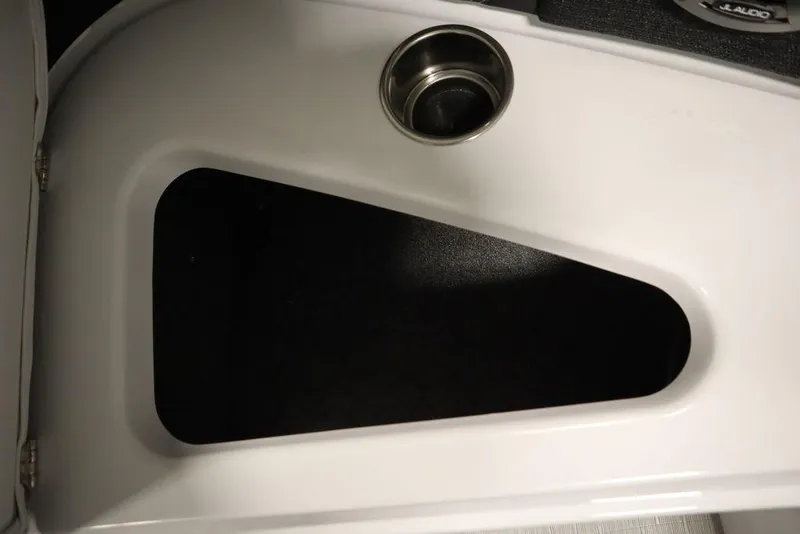 Slide: The Image of 2025 Four Winns H2 boat interior detail with cup holder and storage compartment. - 18