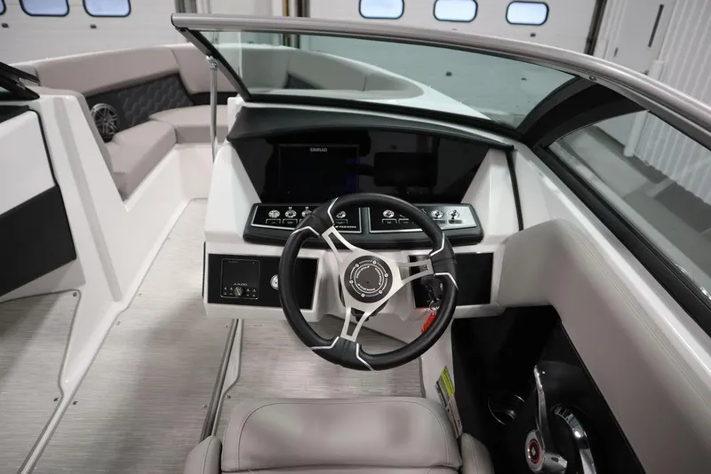Slide: The Image of 2025 Four Winns H2 boat interior with modern steering wheel and dashboard controls. - 22