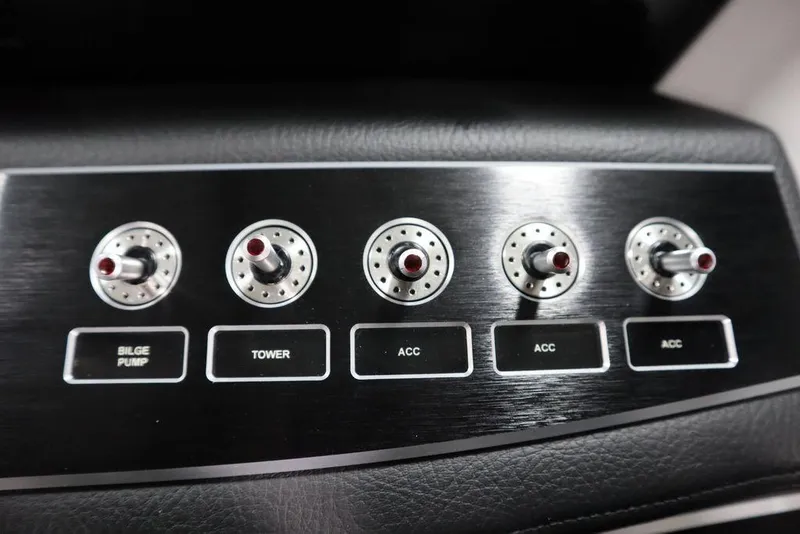 Slide: The Image of 2025 Four Winns H2 control panel with switches for bilge pump, tower, and accessories. - 23