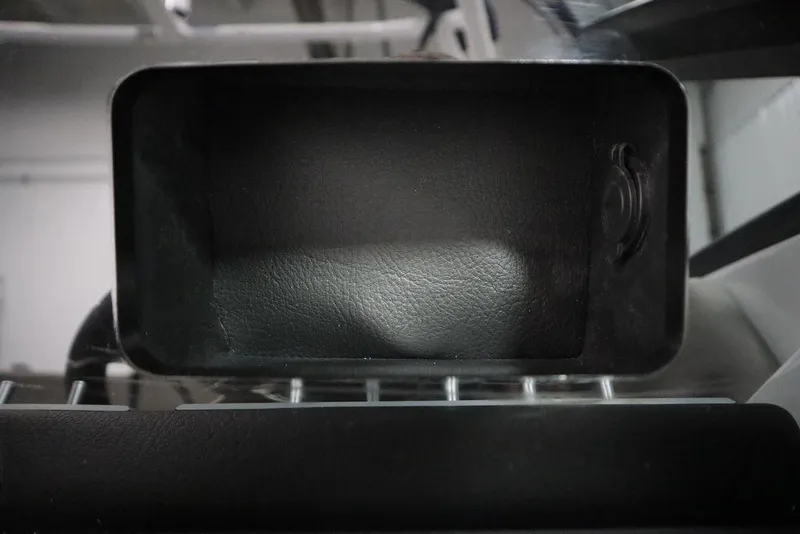 Slide: The Image of Interior compartment of 2025 Four Winns H2 boat, featuring sleek black design. - 24