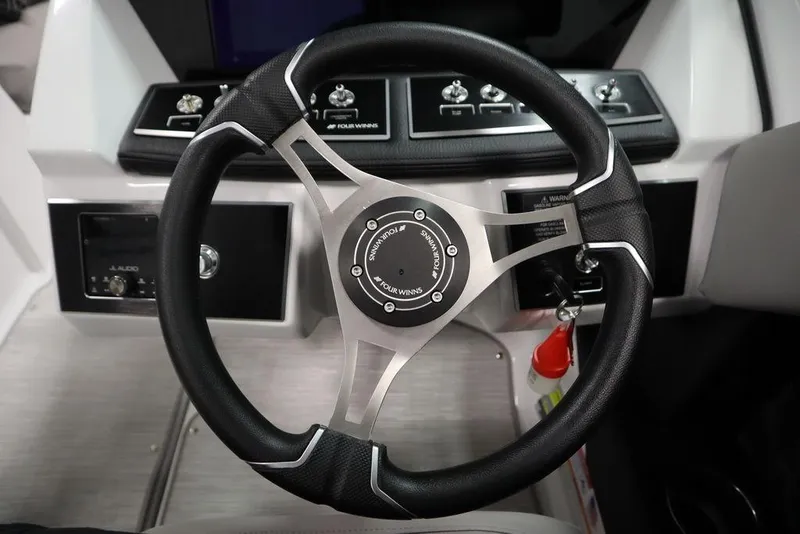 Slide: The Image of Steering wheel of 2025 Four Winns H2 boat, featuring modern controls and sleek design. - 29