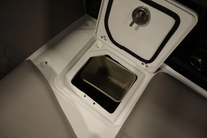 Slide: The Image of 2025 Four Winns H2 boat storage compartment with open lid and secure lock. - 37
