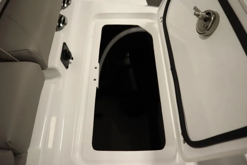 Slide: The Image of Open storage compartment on 2025 Four Winns H2 boat, featuring sleek design and secure latch. - 49