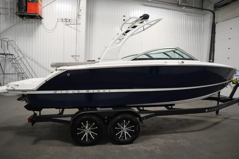 Slide: The Image of 2025 Four Winns H2 boat on trailer in indoor storage facility. - 5