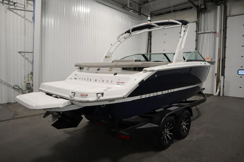 Slide: The Image of 2025 Four Winns H2 boat on trailer in indoor storage facility. - 6