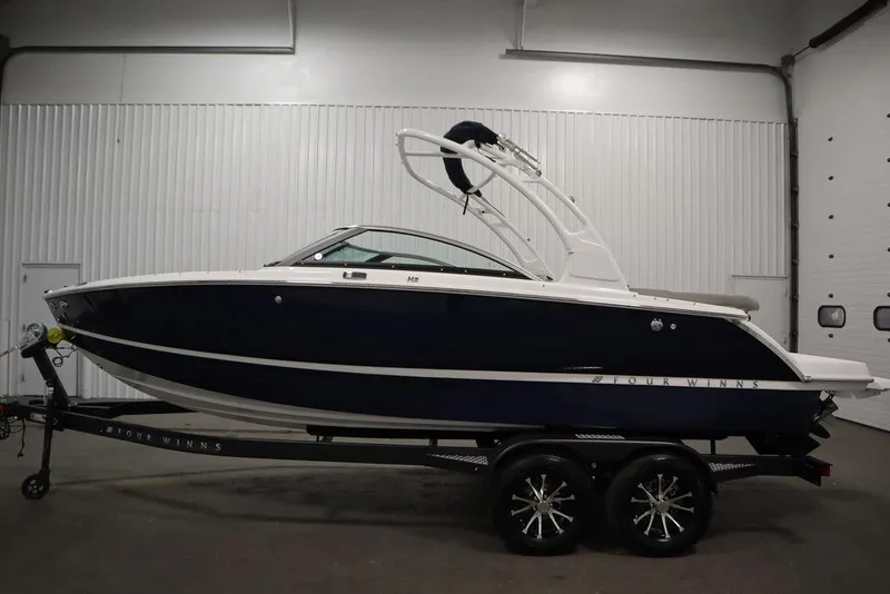 Slide: The Image of 2025 Four Winns H2 boat on trailer in indoor storage facility. - 8