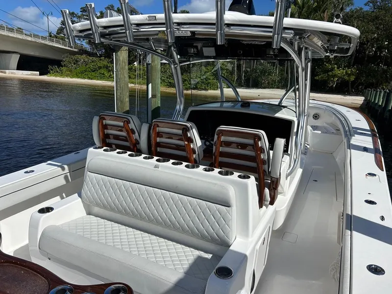 Slide: The Image of 2020 Valhalla Boatworks 41, luxurious seating, sleek design, docked by a serene waterway. - 41