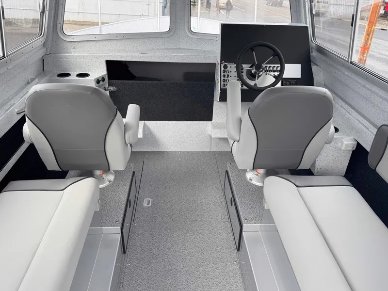 Slide: The Image of Interior of 2025 KingFisher 2625 Coastal Express boat with modern seating and steering console. - 3