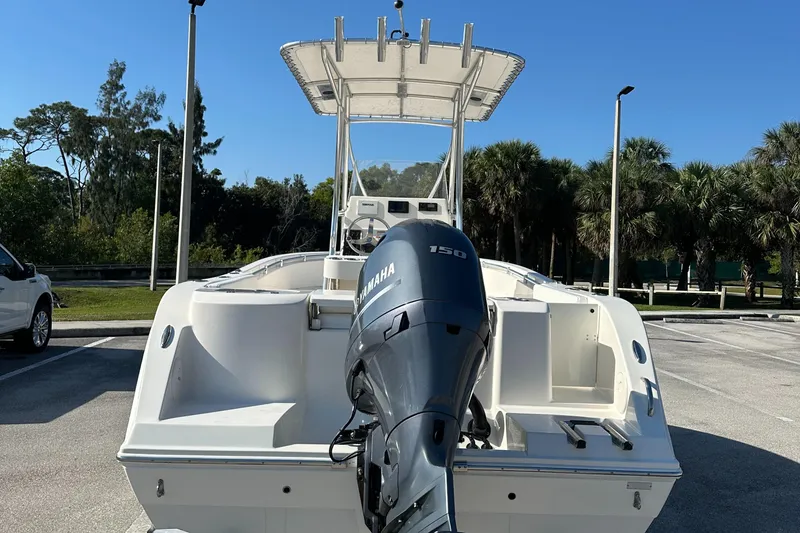 Slide: The Image of 2022 Cobia 201 Center Console boat with Yamaha engine, parked outdoors. - 3