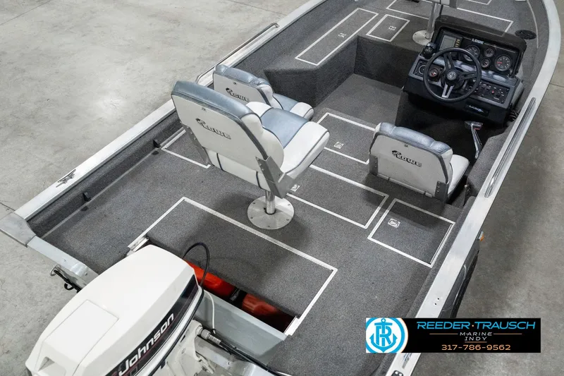 Slide: The Image of 1990 Lowe 1700 boat interior with Johnson motor, featuring two seats and a steering console. - 12