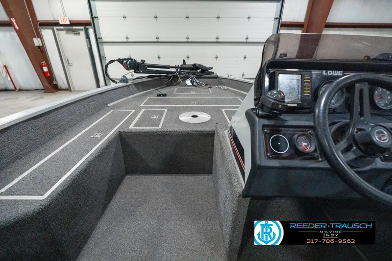 Slide: The Image of Interior of a 1990 Lowe 1700 boat with steering wheel and control panel. - 15
