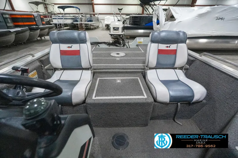 Slide: The Image of Interior of a 1990 Lowe 1700 boat with dual seats and control panel. - 18