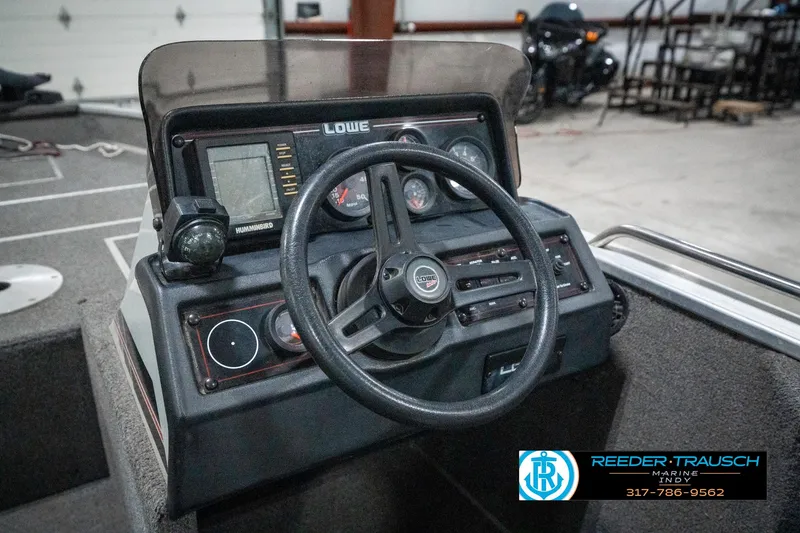 Slide: The Image of Steering console of a 1990 Lowe 1700 boat with gauges and controls. - 27