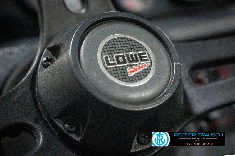 Slide: The Image of Steering wheel of a 1990 Lowe 1700 boat, featuring the Lowe logo. - 28